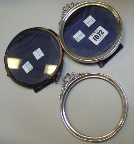 Appraisal: A pair of silver mounted circular photograph frames with ribbon