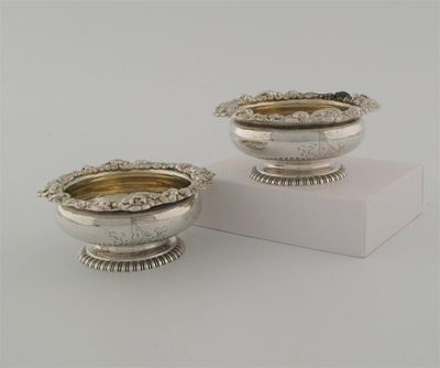 Appraisal: A pair of George III squat circular salts on gadrooned