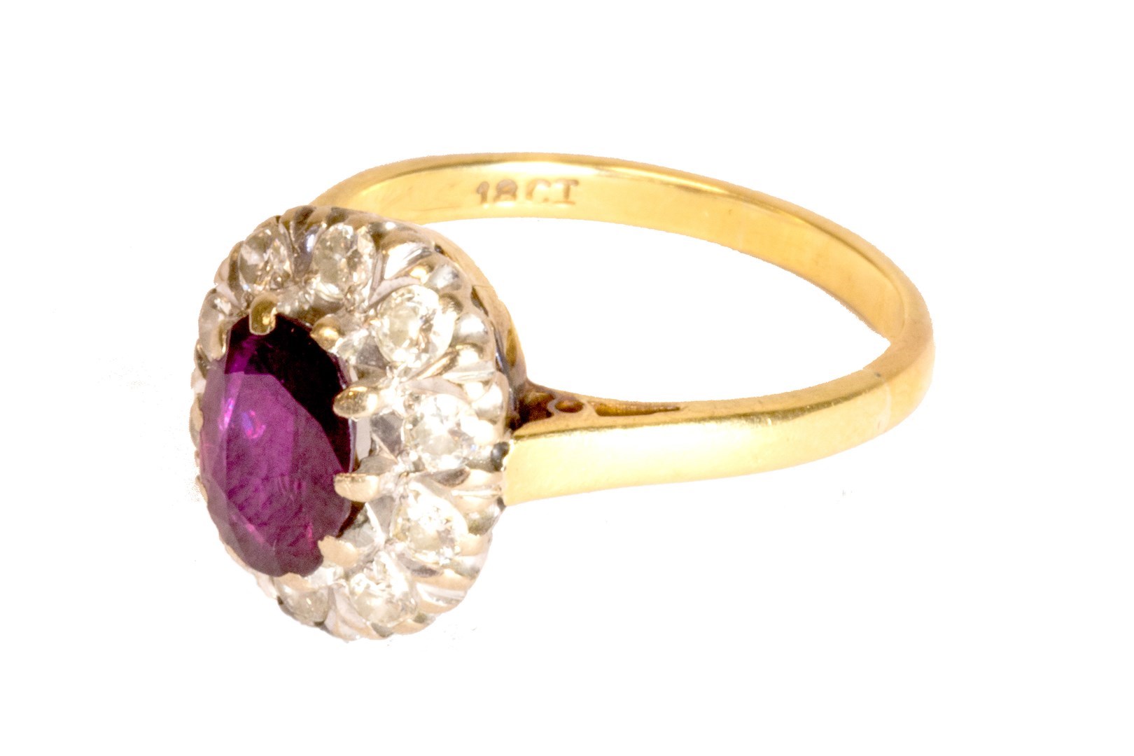 Appraisal: A gold ruby and diamond set oval cluster ring claw