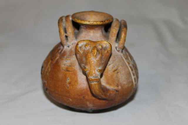 Appraisal: A SMALL PERUVIAN TREACLE GLAZE POT with elephant tusk handle