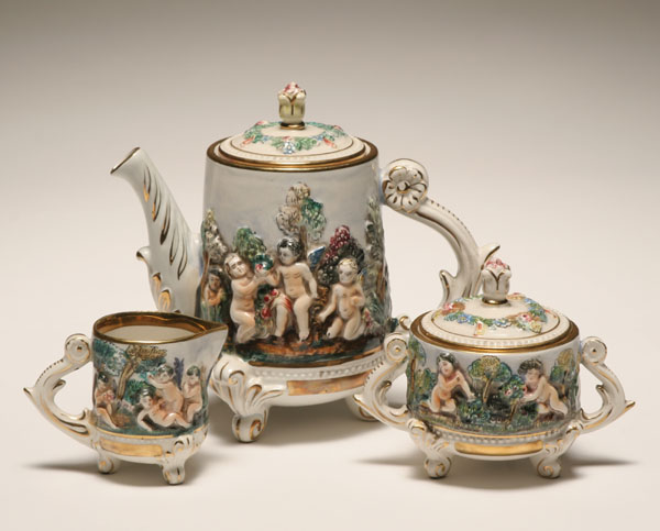 Appraisal: Capo di Monte three piece tea set frolicking putti design