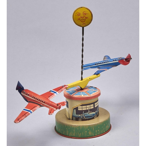 Appraisal: A German lithographed tinplate and plastic clockwork spinning aeroplanes toy