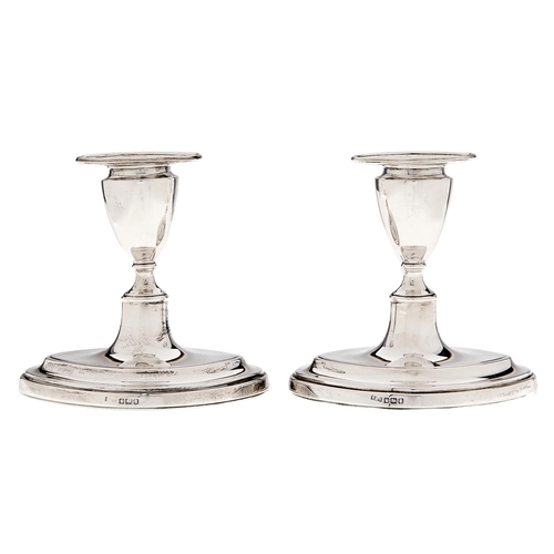 Appraisal: A pair of Edwardian silver dwarf navette shaped candlesticks nozzles