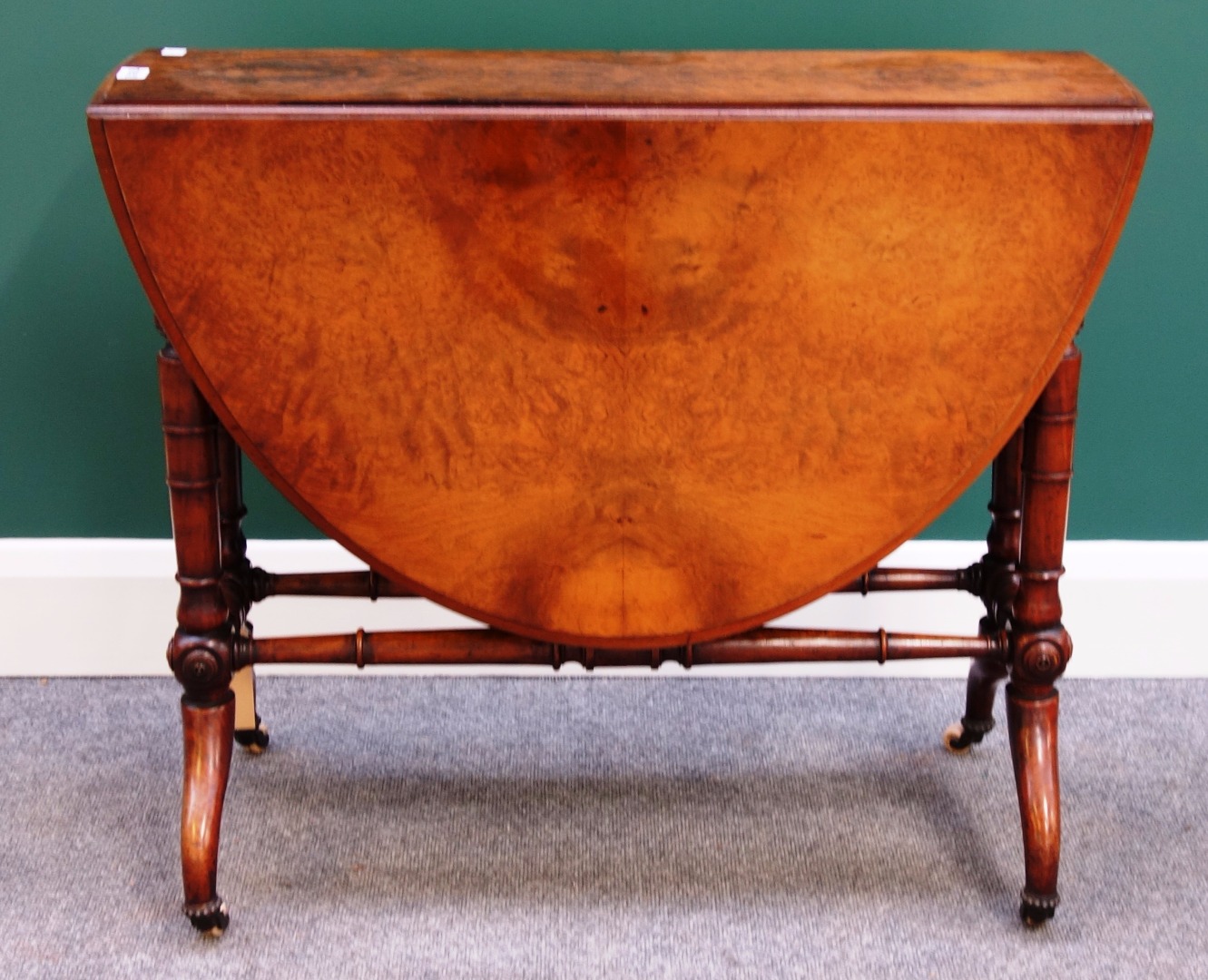 Appraisal: A Victorian figured walnut Sutherland table on turned supports cm