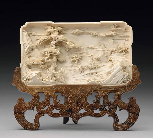 Appraisal: A carved ivory plaque depicting a landscape scene Carved in