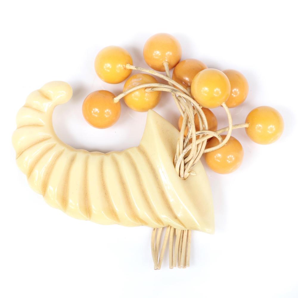 Appraisal: VINTAGE BAKELITE CARVED CREAM CORNUCOPIA DANGLE BROOCH WITH BUTTERSCOTCH BALL