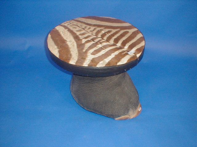 Appraisal: An antique African elephants footstool with a circular zebra skin