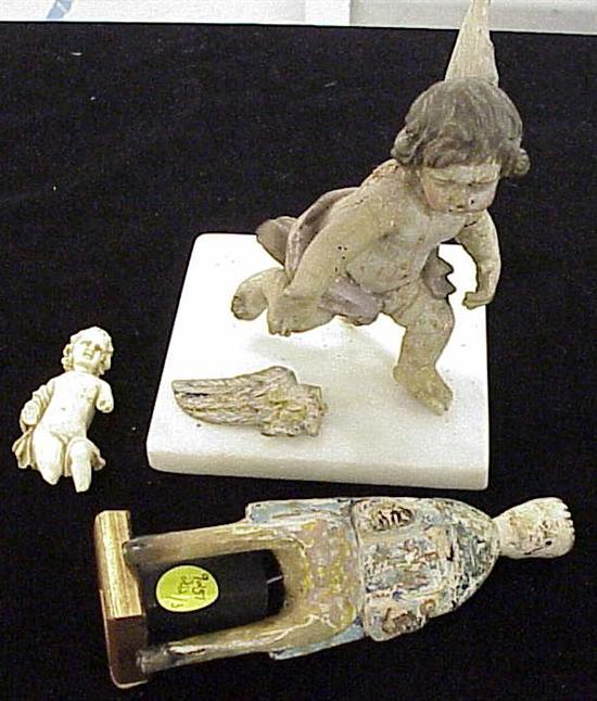 Appraisal: Figural carvings th- th C including polychrome decorated wood putto