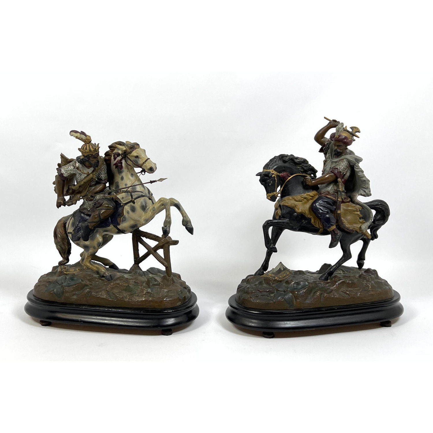 Appraisal: Pr Cold Painted Metal Warriors on Horseback Figures Armored soldiers