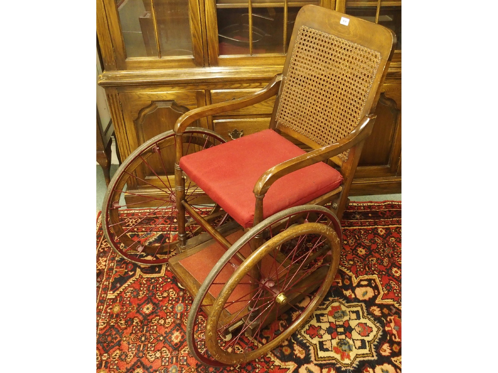 Appraisal: An Edwardian bergere wheelchair by Hughes Birmingham