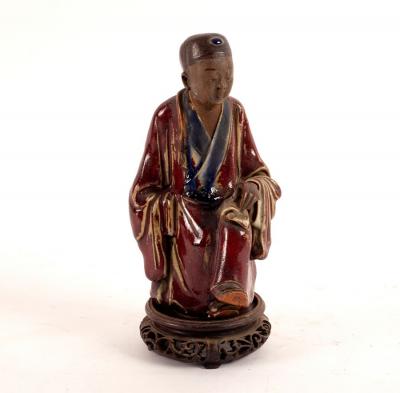 Appraisal: A Chinese stoneware figure of a seated scholar Guangdong late