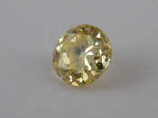 Appraisal: A loose polished round brilliant cut untested yellow diamond approx