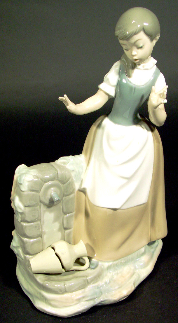 Appraisal: Nao porcelain figurine beside a well printed factory mark to