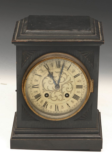 Appraisal: AN EBONISED MANTEL CLOCK with engraved brass dial and striking