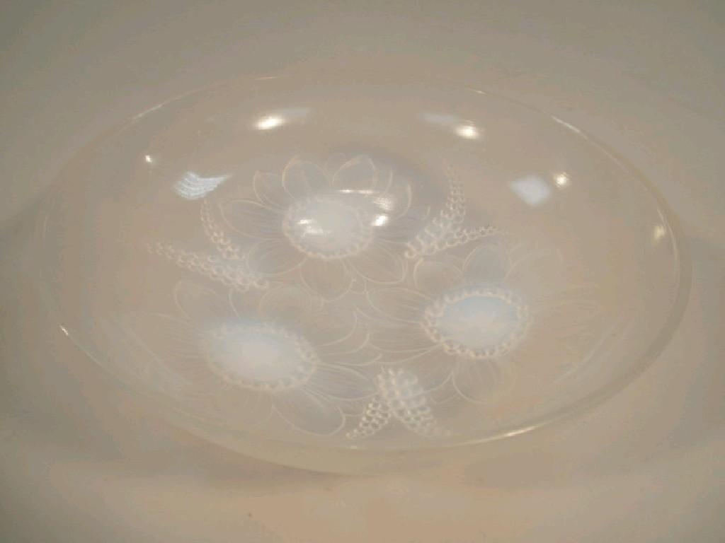 Appraisal: A Sabino opalescent glass bowl supported on three flowerhead feet