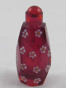 Appraisal: A facet cut ruby glass snuff bottle with applied enamel