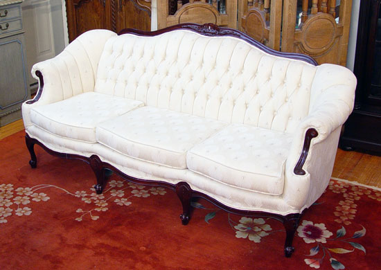 Appraisal: ELEGANT CARVED MAHOGANY SOFA Shaped top rail arms scroll outward