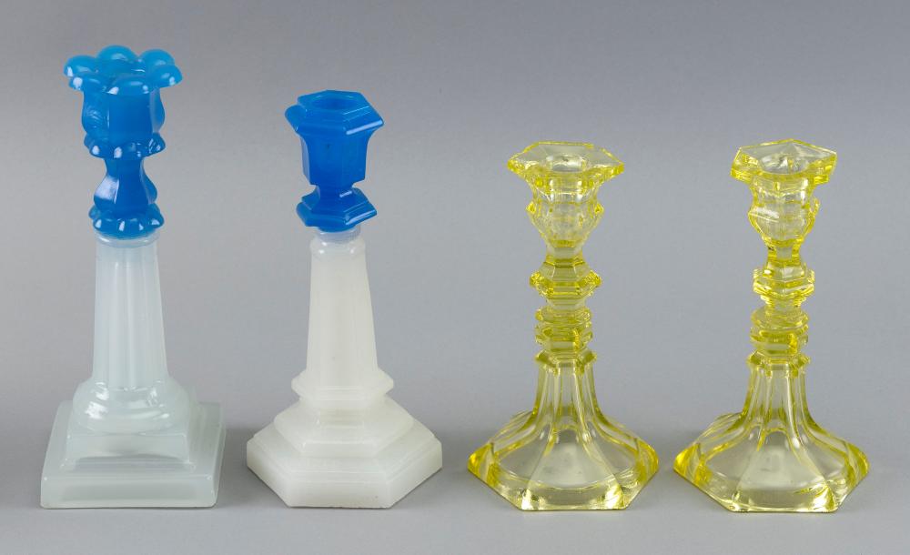 Appraisal: FOUR SANDWICH GLASS CANDLESTICKS TH CENTURY HEIGHTS FROM TO FOUR