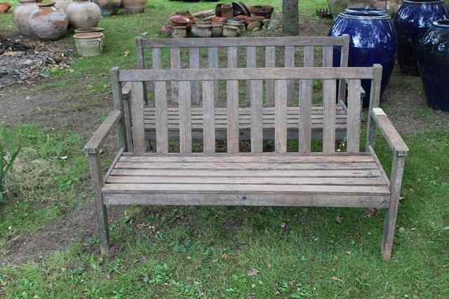 Appraisal: A PAIR OF TEAK GARDEN SEATS wide