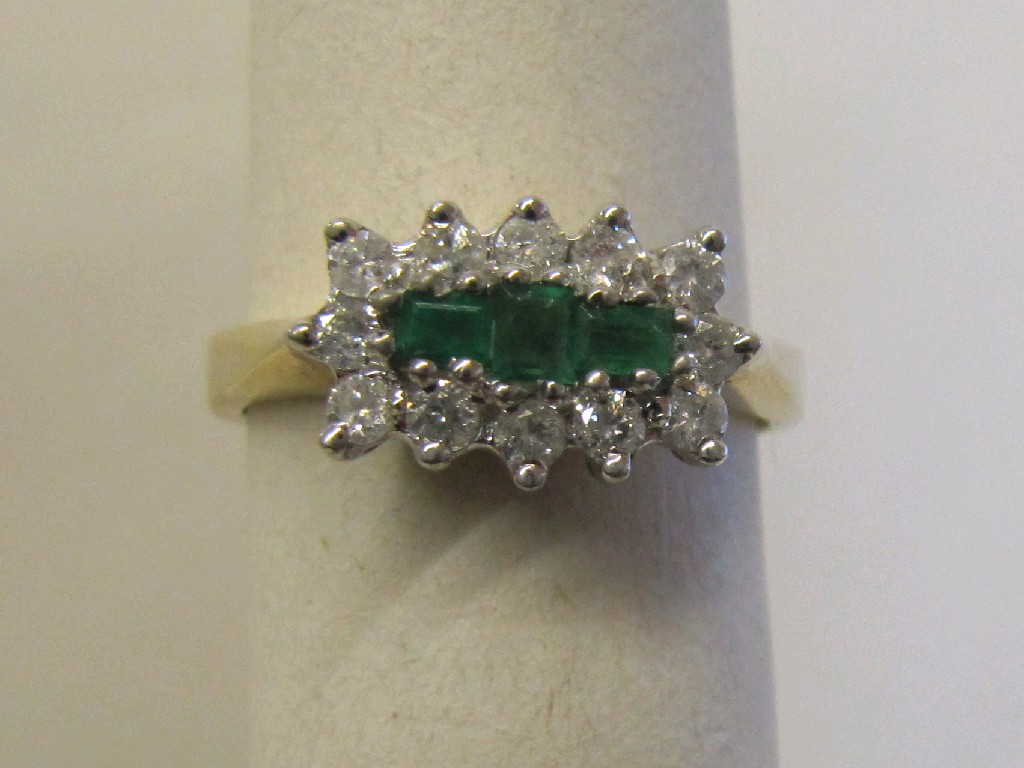 Appraisal: Nine carat gold emerald and diamond cluster ring with three