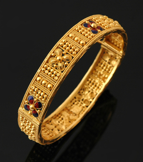 Appraisal: A gold and enamel bangle The pierced filigree and granulated