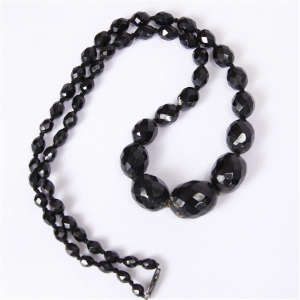 Appraisal: Antique faceted dark cherry amber graduated bead necklace It is