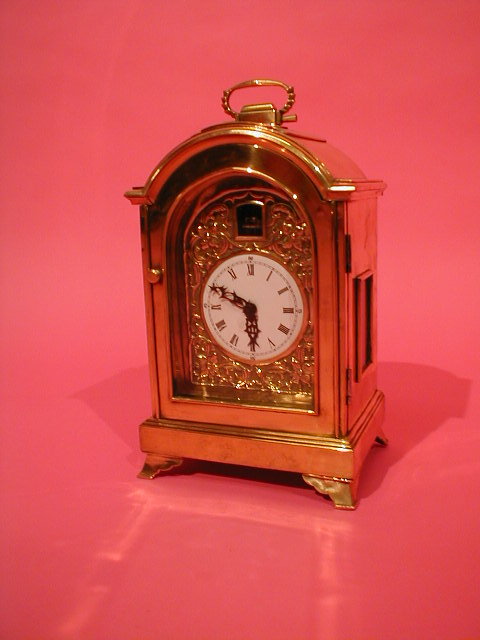 Appraisal: A brass bracket clock with enamelled dial and exposed escapement