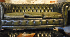 Appraisal: A deep-buttoned green leather Chesterfield sofa cm