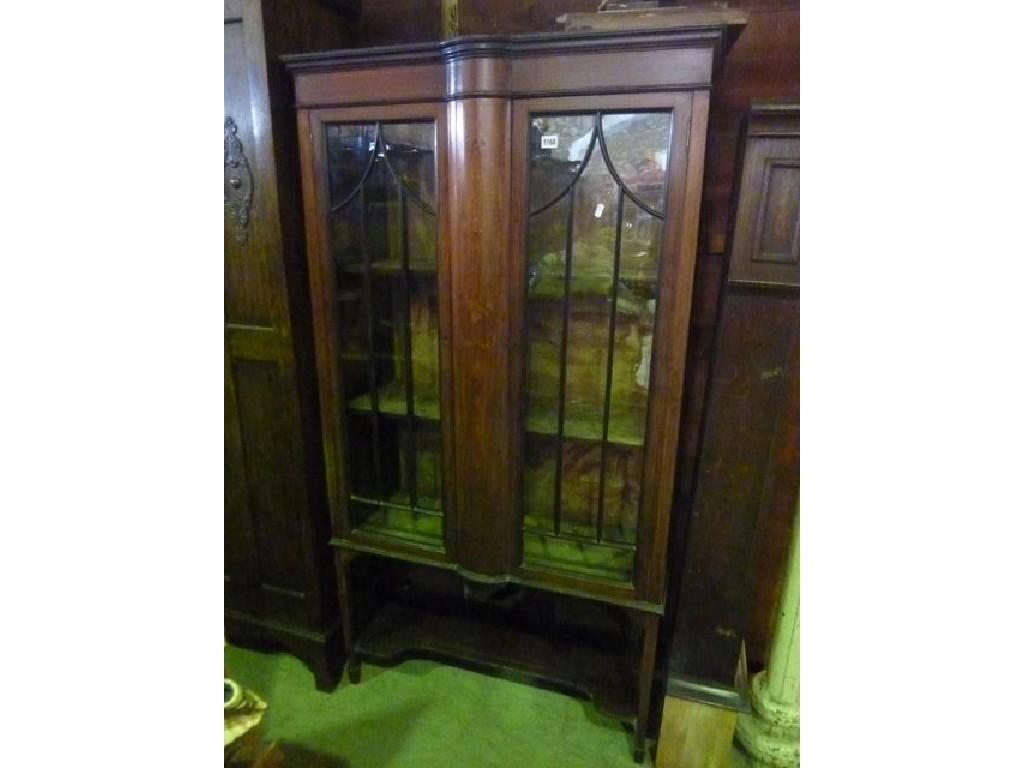 Appraisal: An inlaid Edwardian mahogany freestanding china display cabinet enclosed by