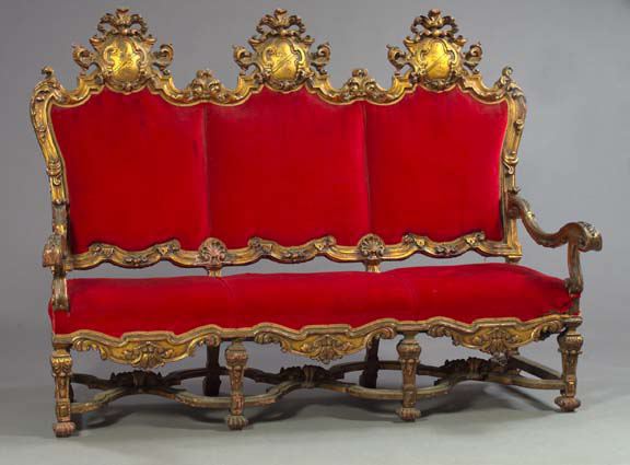 Appraisal: Baronial-Style Giltwood Settee early th century the padded triple-back settee