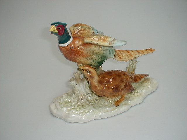 Appraisal: A porcelain figure group of a cock and hen pheasants