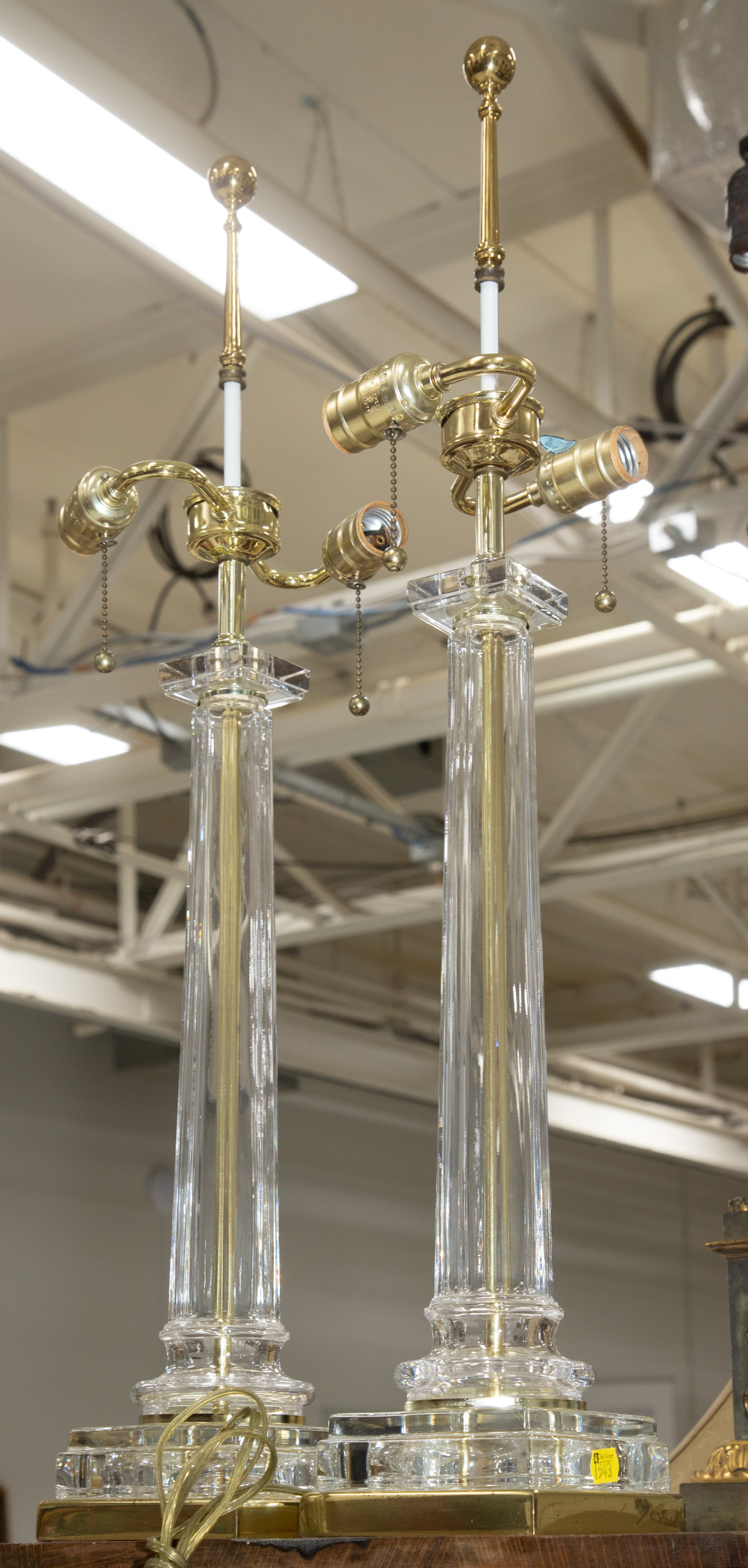 Appraisal: A PAIR OF GLASS TABLE LAMPS Modern with bright brass