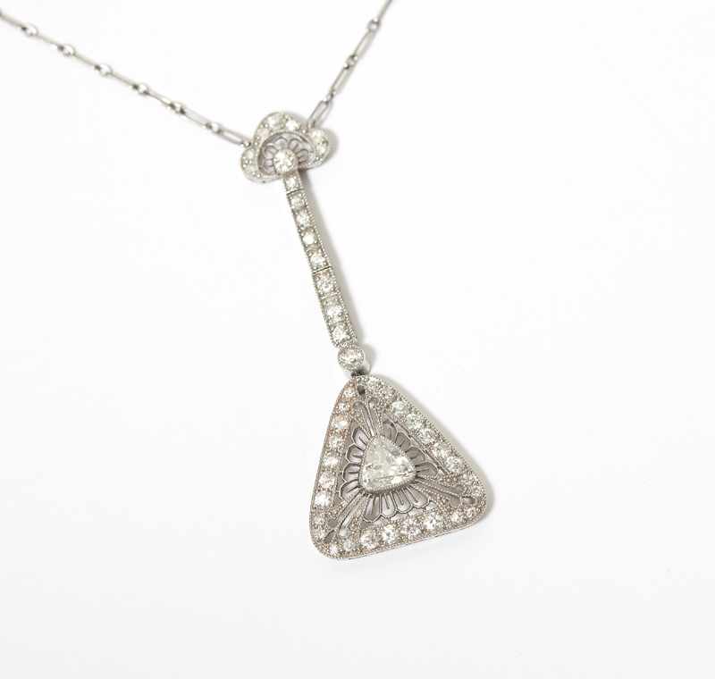 Appraisal: A diamond and platinum necklace The triangular shape diamond center