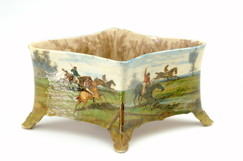 Appraisal: CHARLES VOLKMAR Large four-footed jardiniere painted in barbotine with a