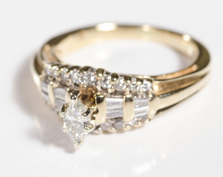 Appraisal: DIAMOND AND FOURTEEN KARAT GOLD RING with round-cut and baguette-cut