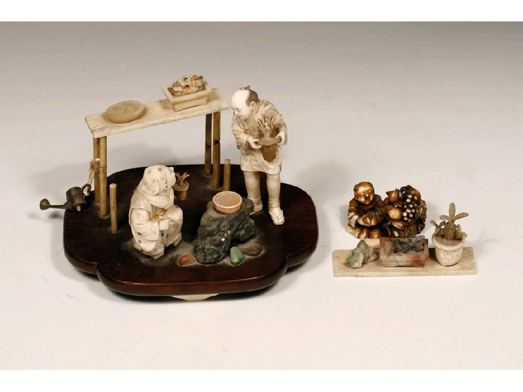 Appraisal: A JAPANESE IVORY AND WOOD SECTIONAL CARVING OF FIGURES IN