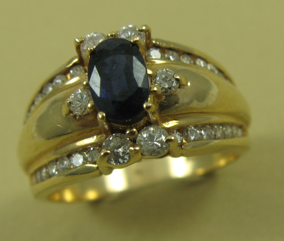 Appraisal: SAPPHIRE AND FOURTEEN KARAT GOLD RING centering an oval-cut dark