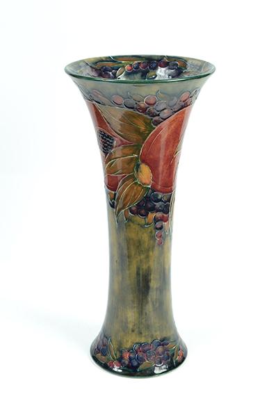 Appraisal: A MOORCROFT POMEGRANATE PATTERN VASE fluted body decorated with leaf