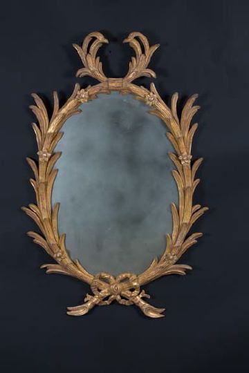 Appraisal: Italian Carved Oval Giltwood Looking Glass in the neoclassical taste