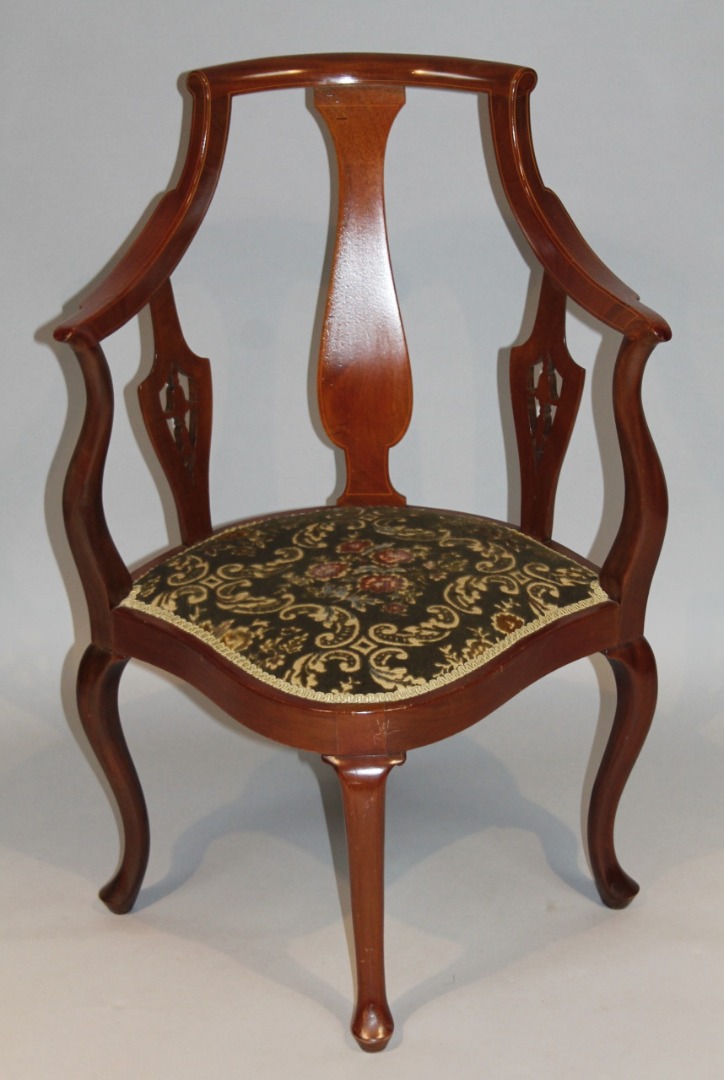 Appraisal: An Edwardian mahogany salon chair with a tricorn seat and