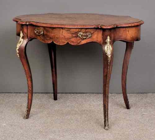 Appraisal: A Victorian figured walnut and gilt metal mounted occasional table