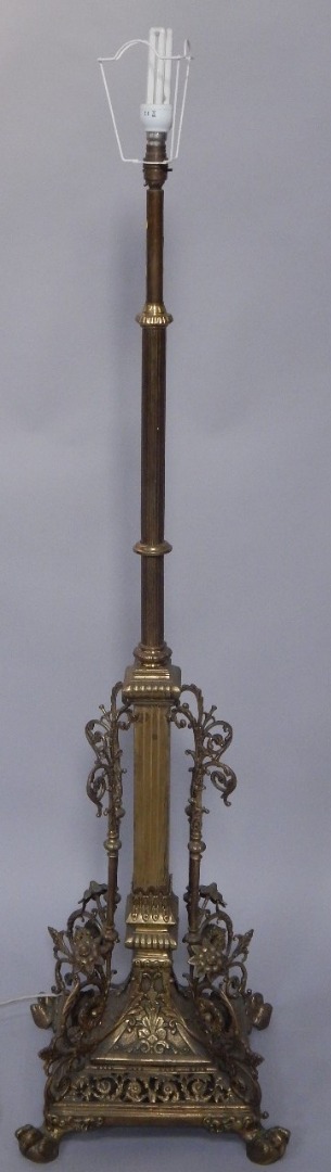 Appraisal: An early thC brass adjustable standard lamp the base applied