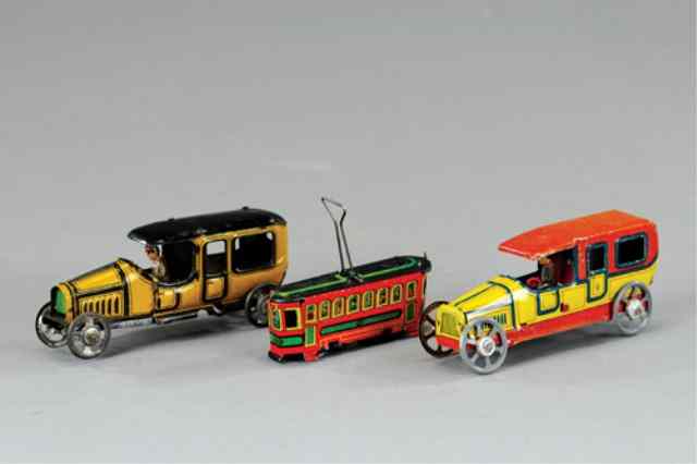 Appraisal: THREE PENNY TOYS Includes a red and yellow G Fischer