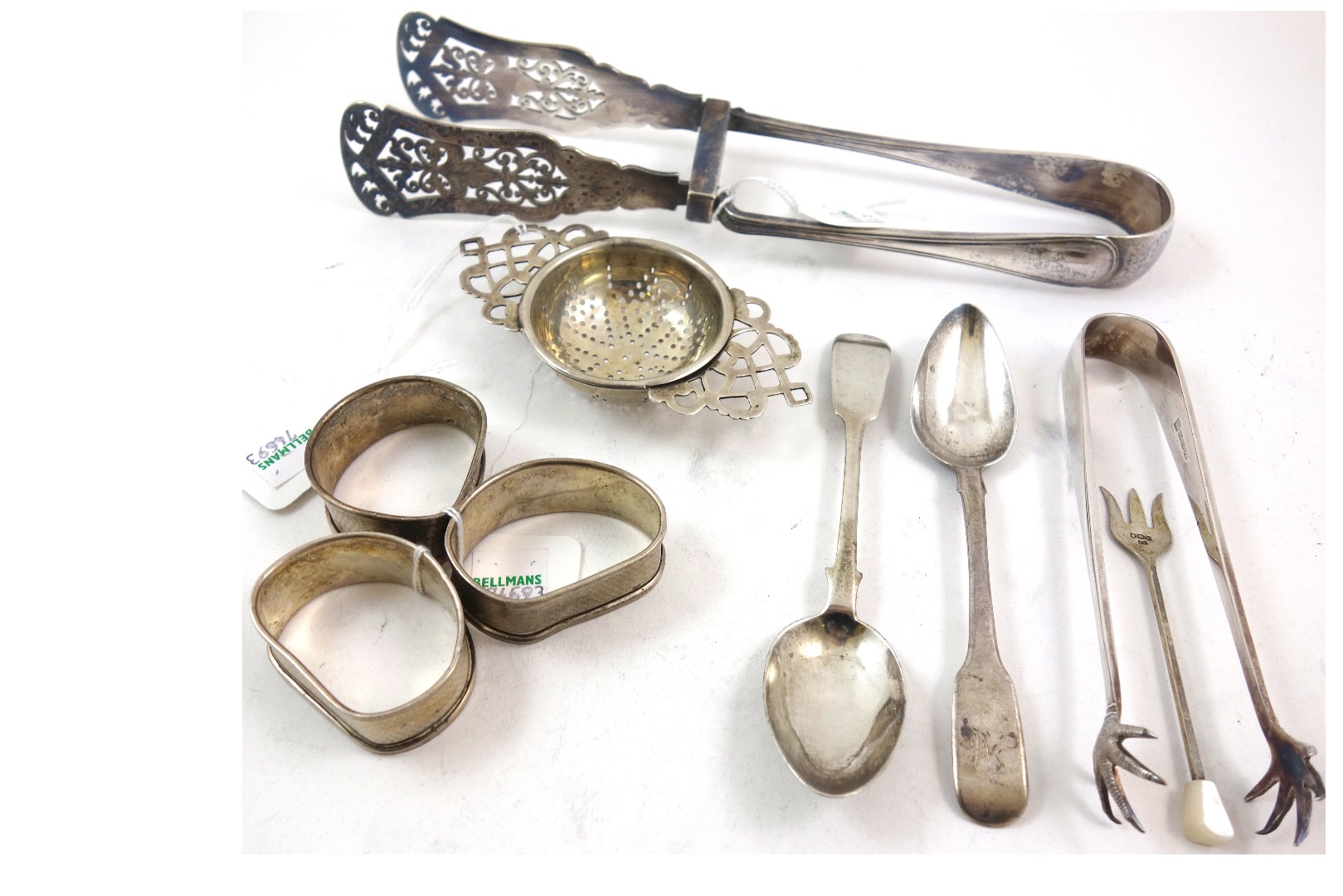 Appraisal: A silver tea strainer Birmingham with pierced side handles cm