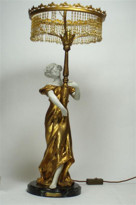 Appraisal: An Art Nouveau ceramic and gilt metal figural lamp of