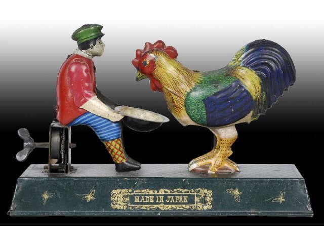 Appraisal: Tin Wind-Up Japanese Boy Feeding Chicken Toy Description Pre-war Working