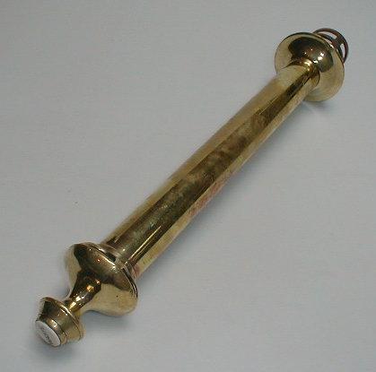 Appraisal: An Edwardian brass bath waste overflow pipe with enamelled button