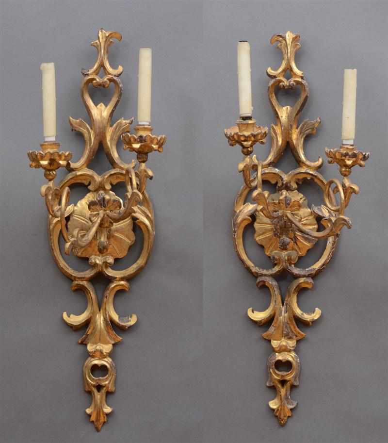 Appraisal: PAIR OF ITALIAN ROCOCO CARVED GILTWOOD TWO-LIGHT WALL APPLIQU S