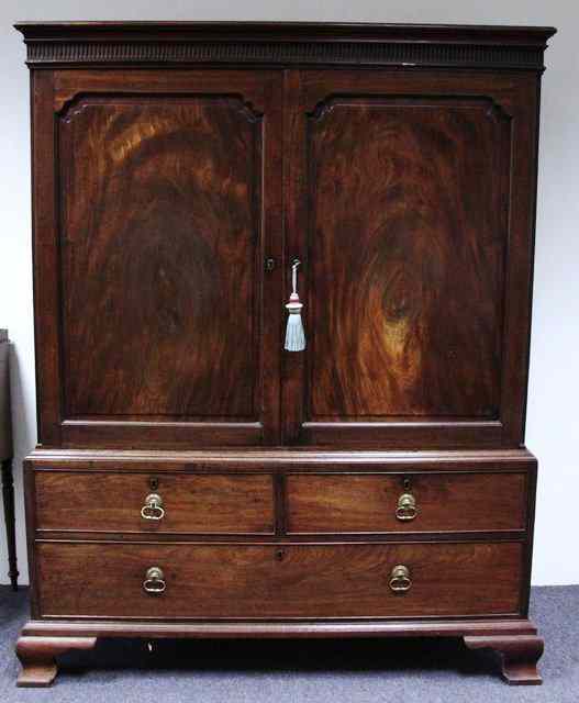 Appraisal: A George II mahogany linen press circa with dentil frieze