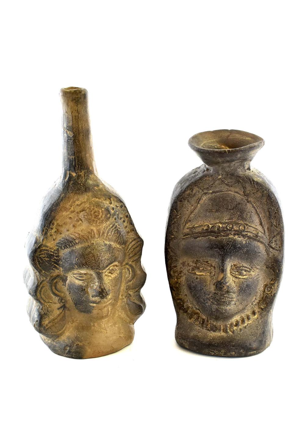 Appraisal: TWO PRE-COLUMBIAN STYLE POTTERY PORTRAIT BOTTLESPeruvian Blackware Tallest in high